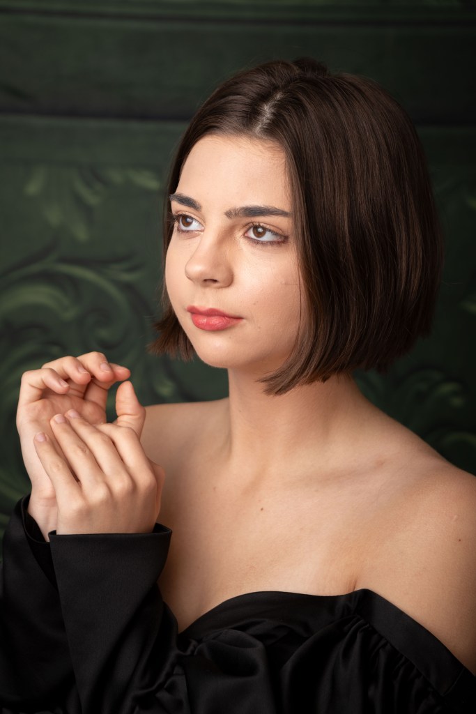 studio senior portrait photograph of a young woman in a formal gown